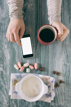 Woman hands , tea, pumpkin cake on wooden table. Toned pictureの写真素材