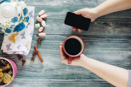 business man using mobile smart phone at wooden table ,smart phone, cup of coffeeの写真素材