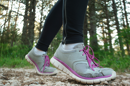 Female athlete runner. closeup on shoe. woman fitness sunset jog workout concept.の写真素材