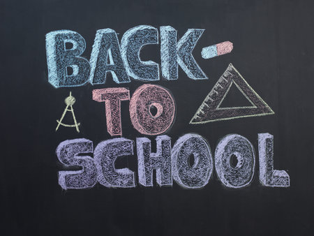 Welcome Back To School Typographical Background On Chalkboard With School Icon Elements