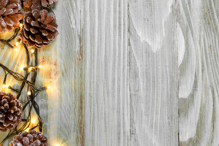 Christmas fir tree with snow on rustic wooden board with copy