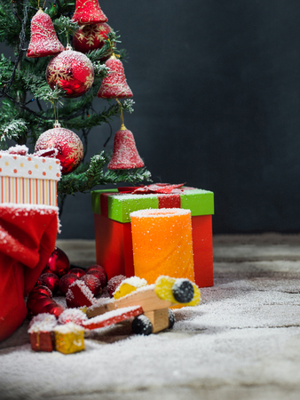 Christmas candles and fir tree branches on a wooden background with toysの写真素材