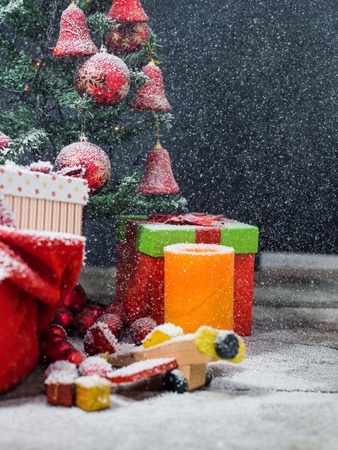 Christmas candles and fir tree branches on a wooden background with toysの写真素材