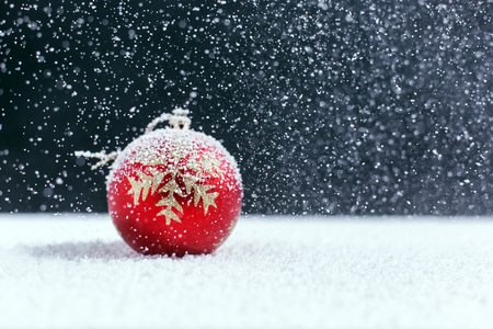 Christmas balls on snow, falling snowの写真素材