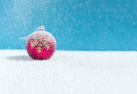 Christmas balls on snow, falling snowの写真素材