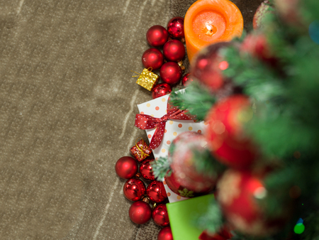 Holidays horizontal background with Christmas fir tree with red,gold and white decoration and cute gift boxes with bowsの写真素材
