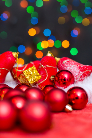Christmas background with a red ornament, golden gift box and fir in snowの写真素材