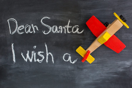 Dear Santa is written on a blackboard and christmas decoration