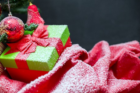 Red, Christmas Decoration On White Snow, Christmas Gifts And Presents With red Ribbon. Vintage Background With Snowflakes And Tree. Festive Snowy Christmas Cardの写真素材