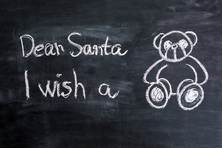 Dear Santa is written on a blackboard and christmas decorationの写真素材