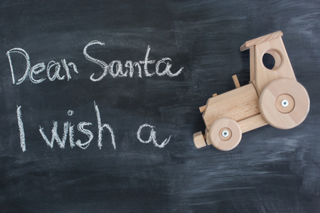 Dear Santa is written on a blackboard and christmas giftの写真素材