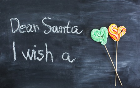 Dear Santa is written on a blackboard and christmas giftの写真素材