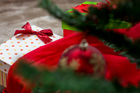 Christmas tree with gift box and decorations on wooden background space for letteringの写真素材