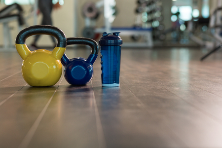 Family sport or weight loss concept. Dumbbells, towel and shaker. Toned image, selective focusの写真素材