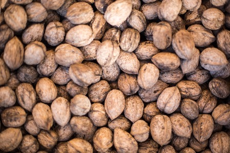 Walnut background, scattered pile of walnutsの写真素材