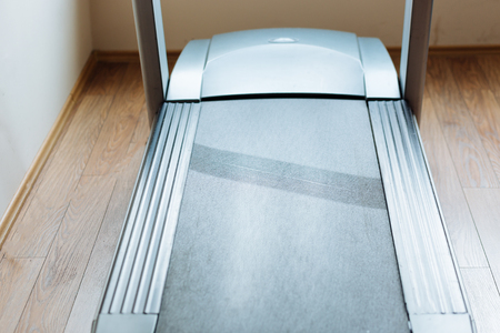 Man running in a gym on a treadmill concept for exercising, fitness and healthy lifestyleの写真素材