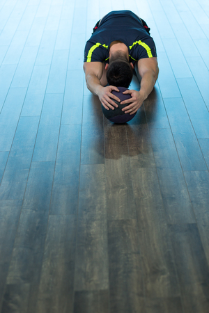 young man doing yoga indoorの写真素材