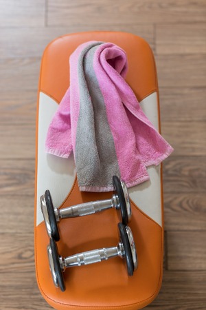 Family sport or weight loss concept. Dumbbells, towel and shaker. Toned image, selective focusの写真素材