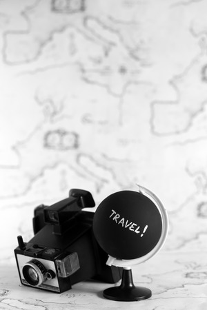 Camera and globe with travel letters on itの写真素材