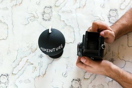 Planning to travel.
Man planning trip around the world. Table from above, man typing on computer, passport, coffee, glasseの写真素材