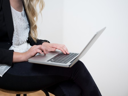 Smiling woman working from home on laptopの写真素材