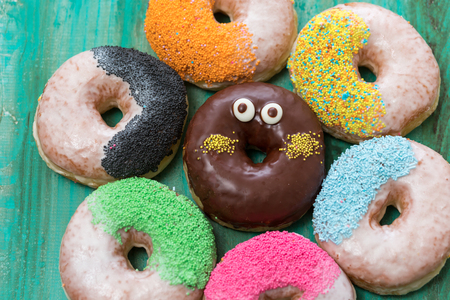 Sweet and vibrant donuts on wooden table,の写真素材