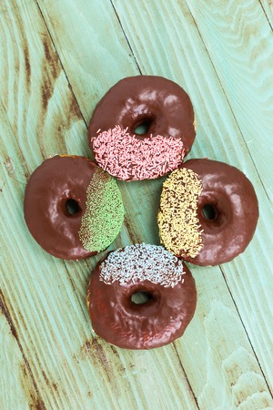 Sweet and vibrant donuts on wooden table,の写真素材