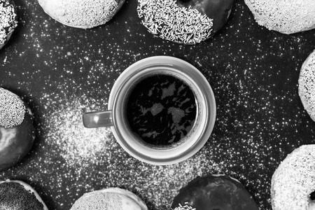Donuts and coffee on stone table. Top view with copy spaceの写真素材