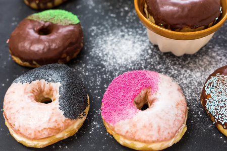 Colorful donuts on stone table. View with copy spaceの写真素材