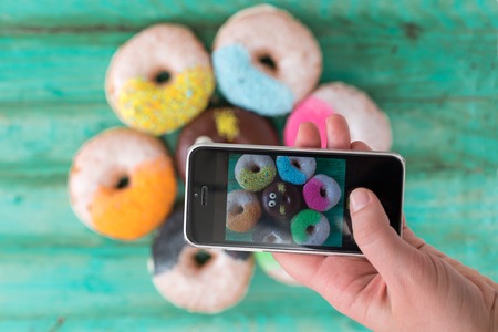 breakfast with donuts , taking photoの写真素材