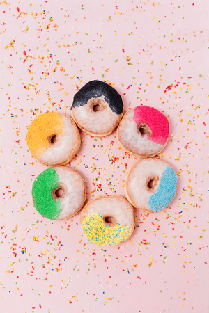 Assorted donuts on a pastel pink background, copyspaceの写真素材