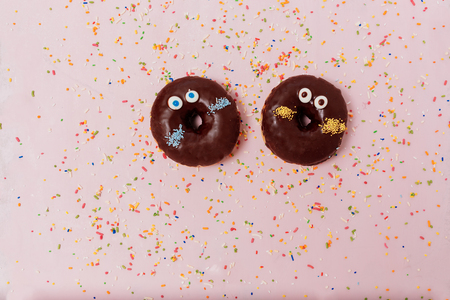 Assorted donuts on a pastel pink background, copyspaceの写真素材