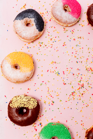 Assorted donuts on a pastel pink background, copyspaceの写真素材
