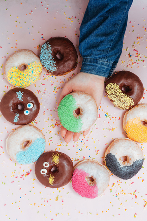female  hand reaching to grab the doughnutの写真素材