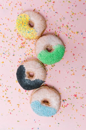 Assorted donuts on a pastel pink background, copyspaceの写真素材