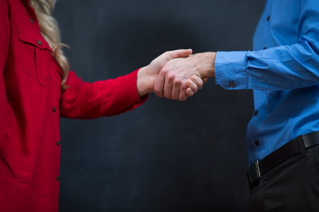 business couple shaking hands at the officeの写真素材