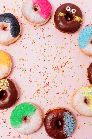 Assorted donuts on a pastel pink background, copyspaceの写真素材
