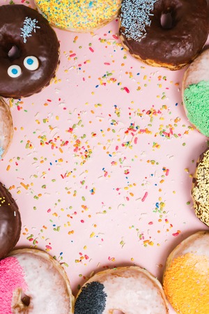 Assorted donuts on a pastel pink background, copyspaceの写真素材