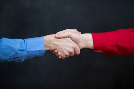 business couple shaking hands at the officeの写真素材