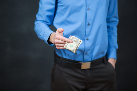 Concept - corruption. Giving a bribe. Money in handの写真素材