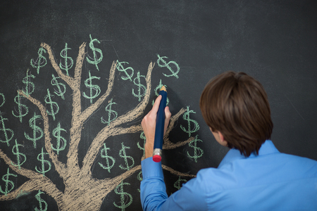 business man is drawing a tree on the chalk blackboard.の写真素材