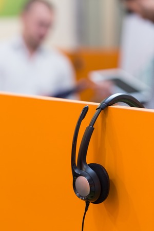 Headphones hanging on cubicle partitionの写真素材