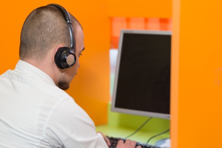 frustrated young business man working on computer at officeの写真素材