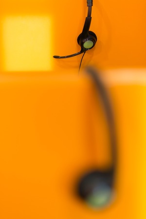 Row of  headphones on desk at corporate officeの写真素材