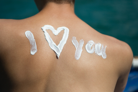 Man With Suntan Lotion At The Beach In Form Of Theの写真素材