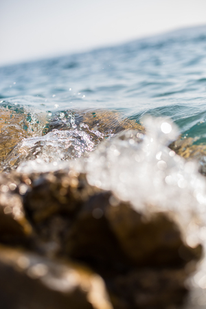 Water splashing the stonesの写真素材