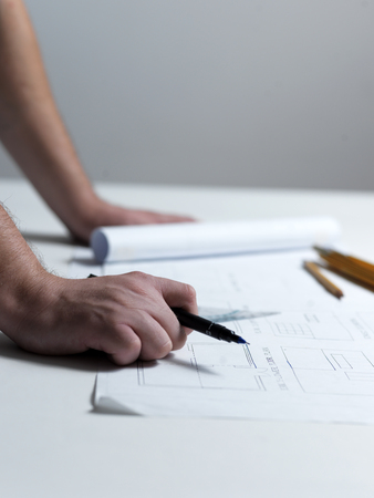 Business man draw buildings and present his architectural projectの写真素材