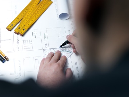Business man draw buildings and present his architectural projectの写真素材