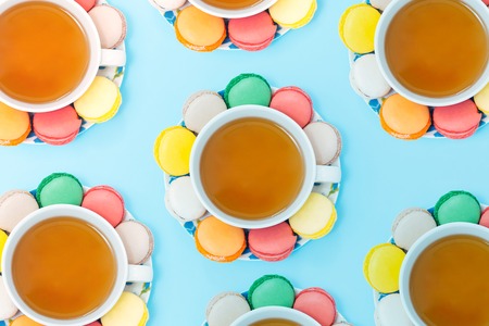 Colorful macaroons with cup of teaの写真素材