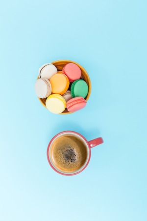 Cup of coffee with milk and macarons on white background. Flat lay, top viewの写真素材